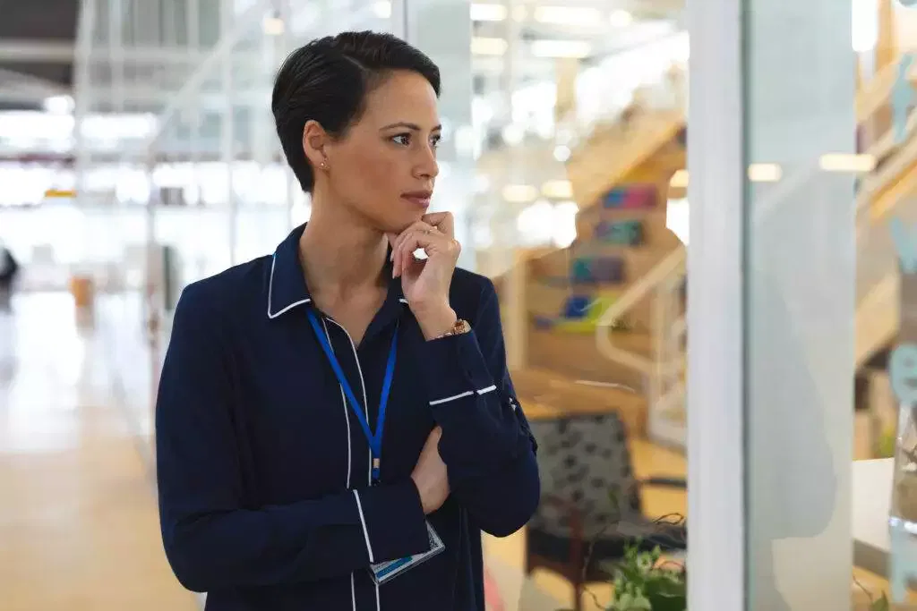 Thoughtful businesswoman considering AFSL or authorized representative options.