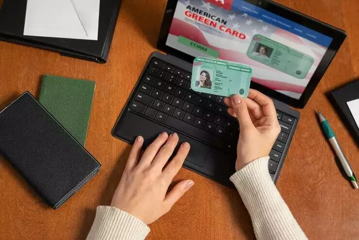 Person reviewing a green card application on a laptop.
