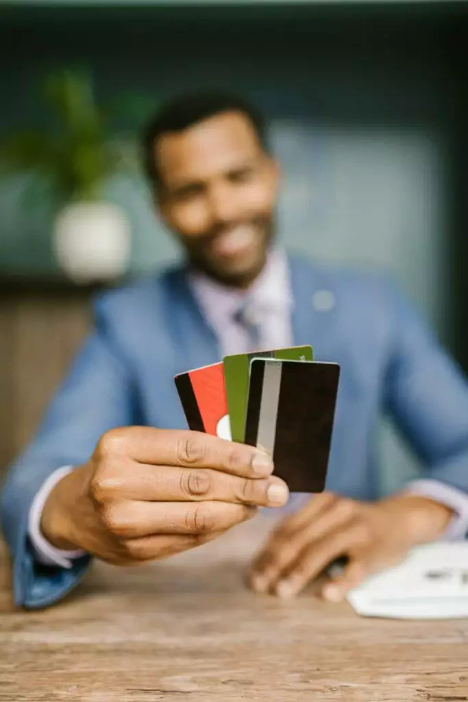 Man holding credit cards, financial planning