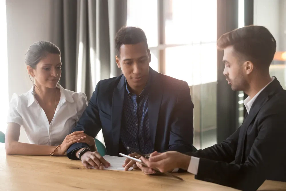 Business professionals reviewing documents, discussing legal or financial matters.