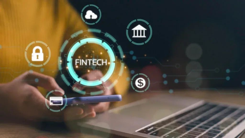 Fintech icons around a person using a smartphone and laptop. Fintech concept.