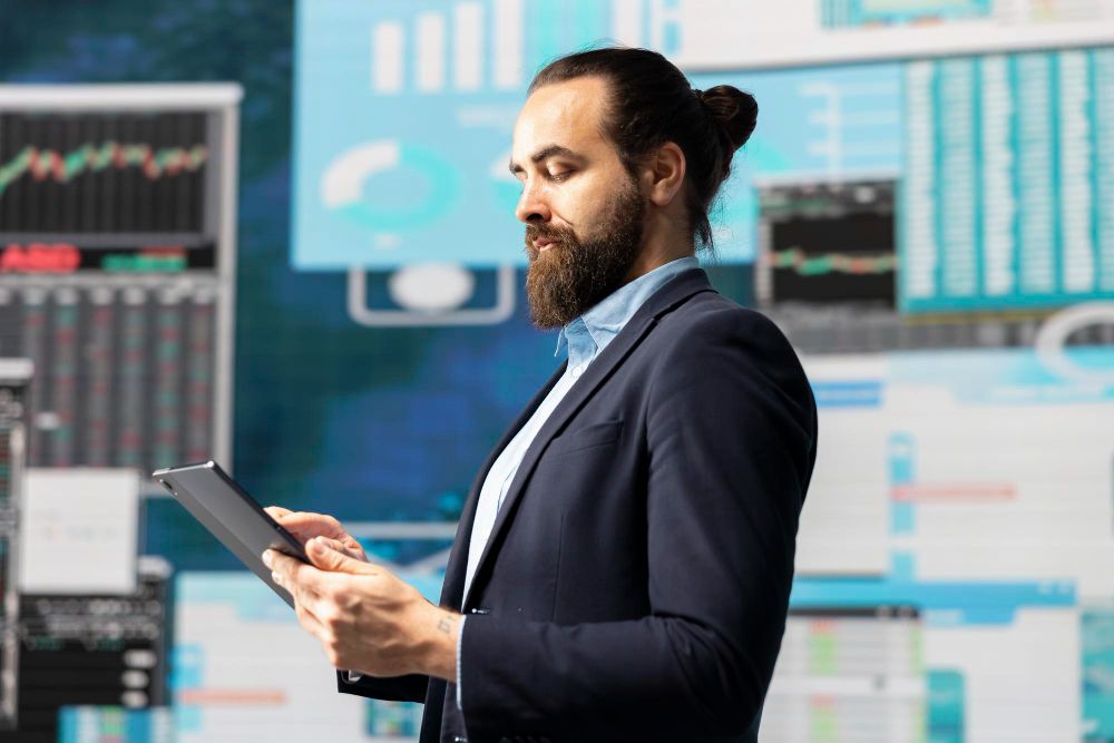 Man in suit analyzing data on a tablet, surrounded by crypto market charts. Digital asset analysis.