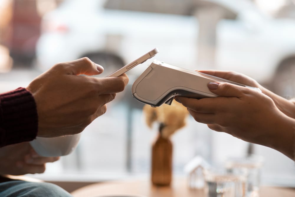 Contactless payment with phone at POS terminal. Non-Cash Payment (NCP) method.