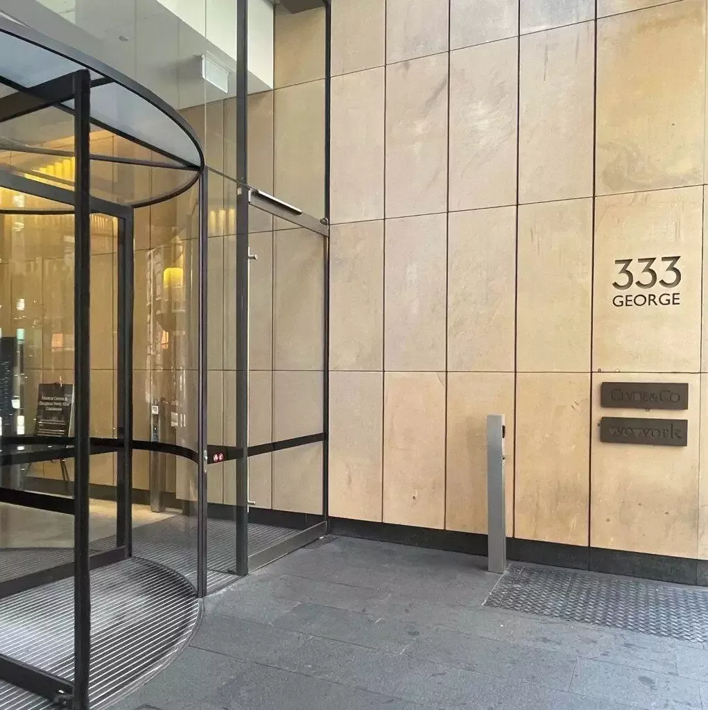 Modern office building entrance at 333 George St, featuring Clyde & Co and WeWork signage.