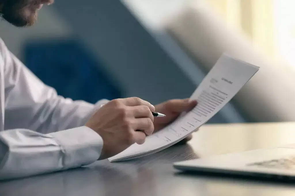 Person reviewing financial document, applying for Australian Financial Services Licence (AFSL).