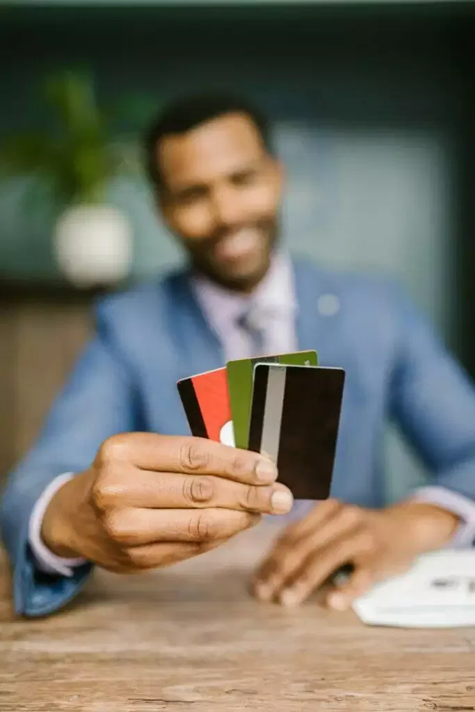 Man holding credit cards, financial planning