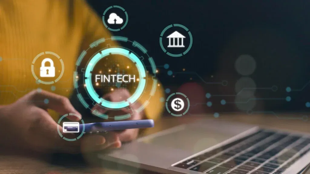 Fintech icons around a person using a smartphone and laptop. Fintech concept.